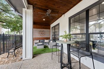 A patio with a table and chairs at The Ambrose, Texas, 77040